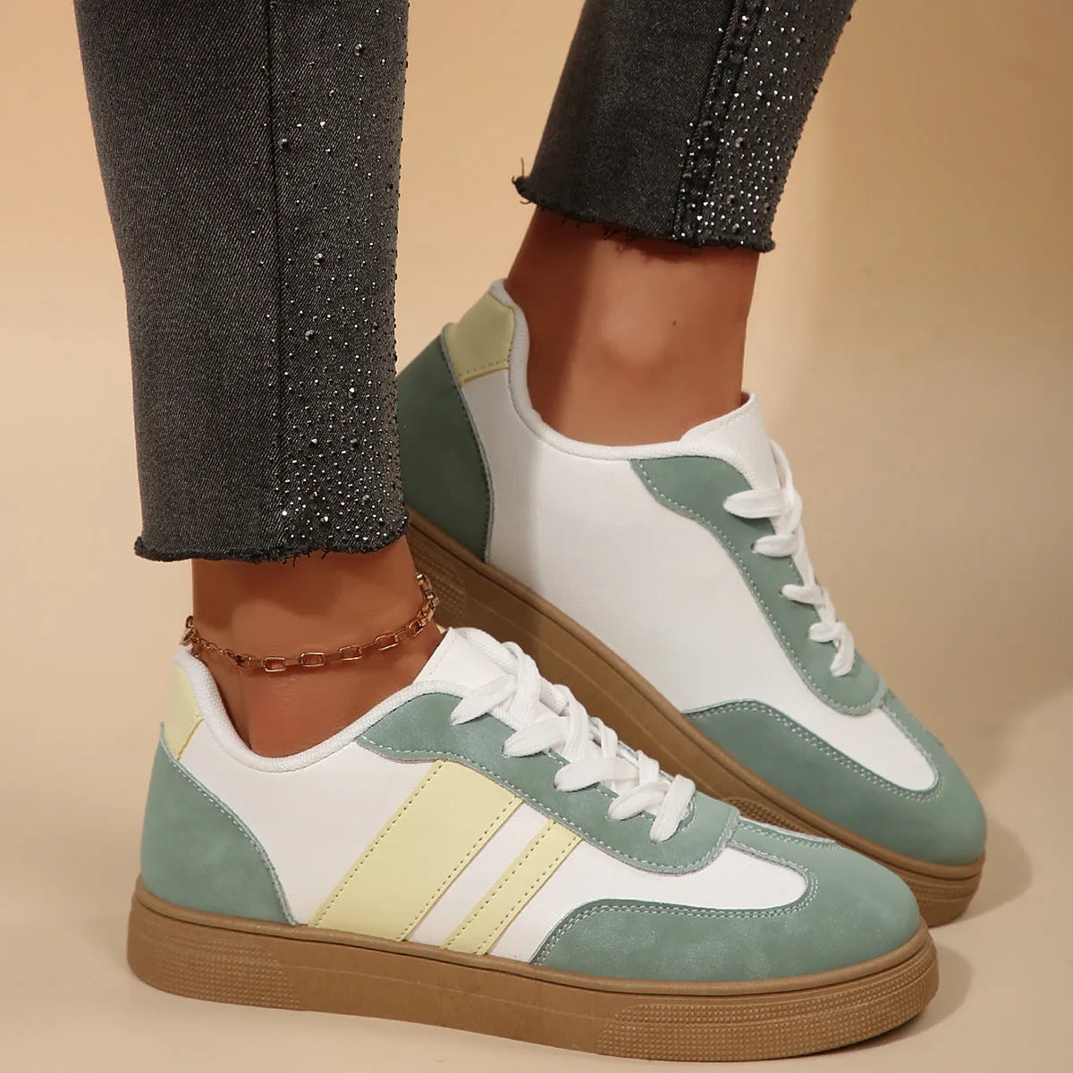 Green women's retro sports shoes with white cross straps and a low flat heel