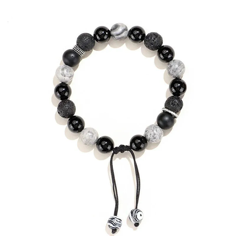 Black agate map stone diamond-shaped volcanic rock bracelet on a wrist, showing New Chinese style.