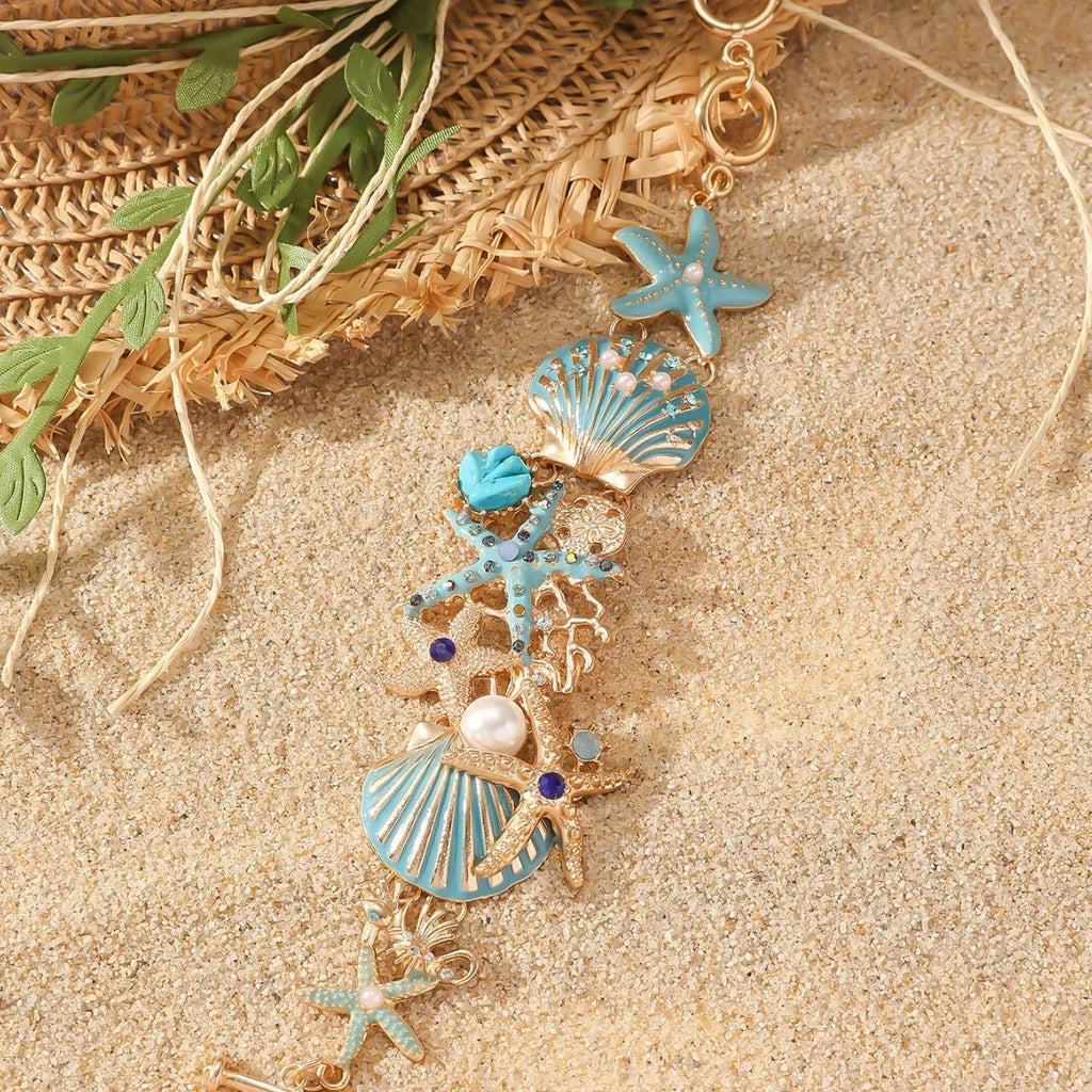 Women's alloy marine theme bracelet with boat anchor, shell, and starfish design in blue.