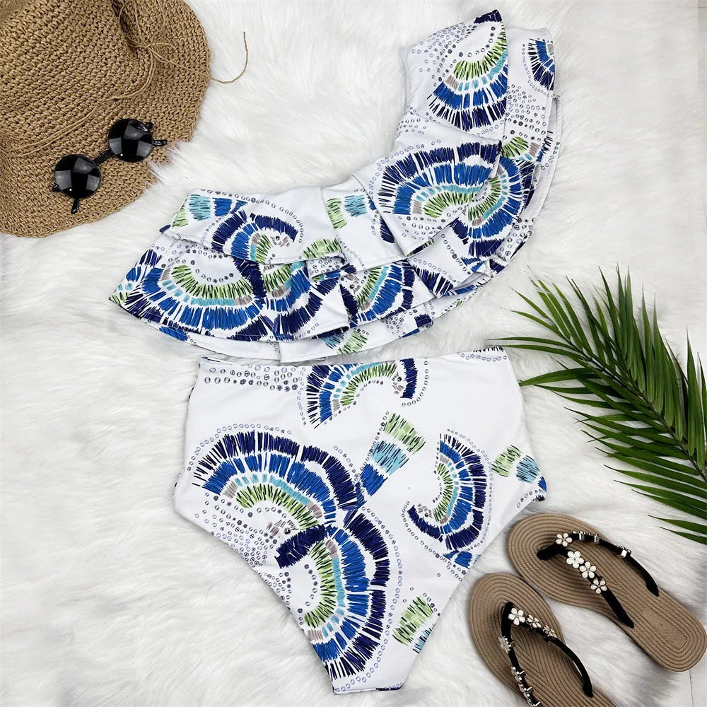 White women's one-shoulder swimsuit with large lotus leaf detail and split-leg design