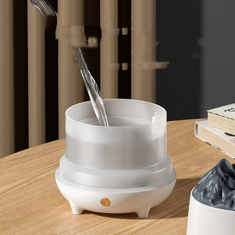 White volcano-shaped ultrasonic humidifier with USB cable on wooden table