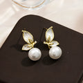 Butterfly-shaped drop earrings for women with oil painting design and zircon stone accents on copper.