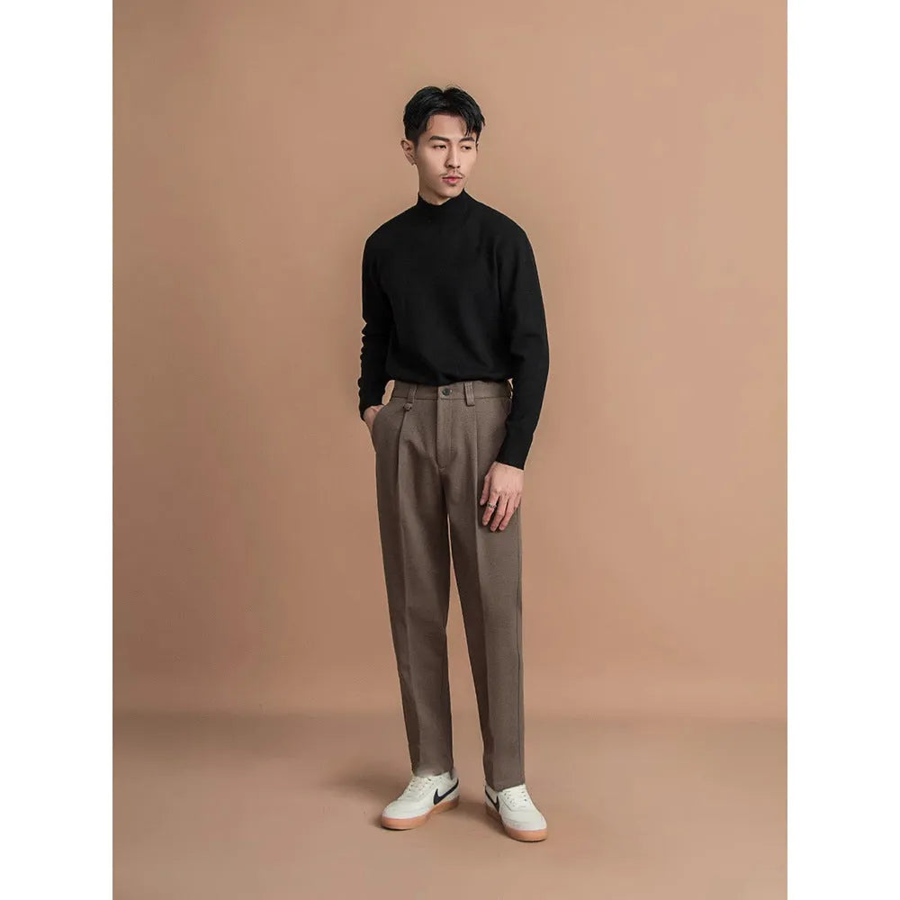 Men's straight-leg polyester trousers in black, shown in a business casual setting.
