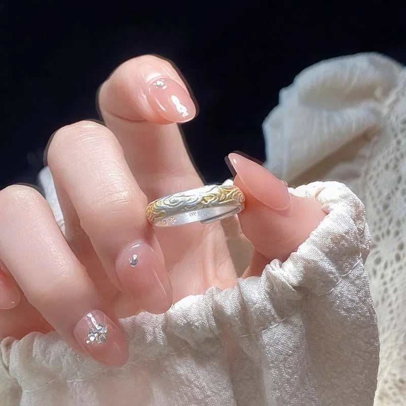 Open-mouth geometric ring with engraved xiangyun pattern in electroplated white copper showing silver and gold finish options