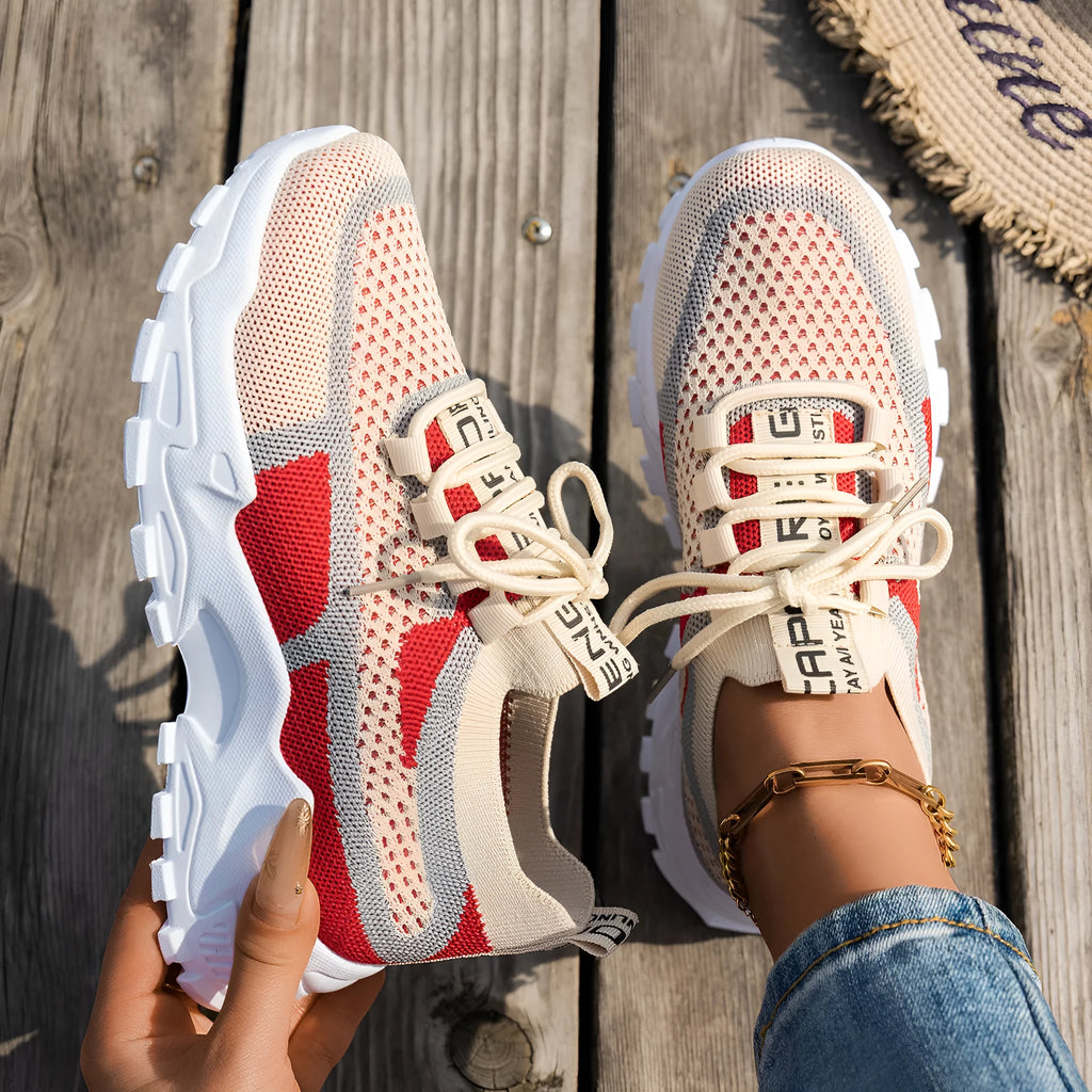 Women's Flyknit mesh lace-up sneakers in a multi-tonal colour with a flat rubber sole.