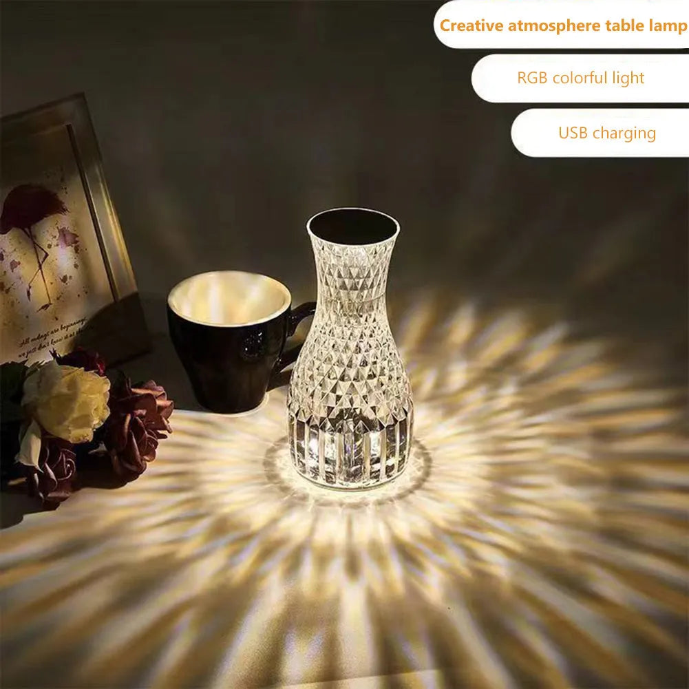 Vase-shaped crystal table lamp with LED lights and remote control on wooden bedside table