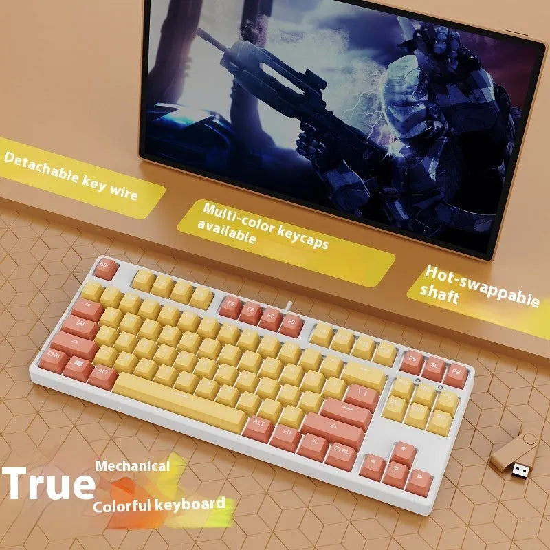 87 key wired mechanical keyboard with metal chassis shown in a black, orange, and yellow colour configuration.