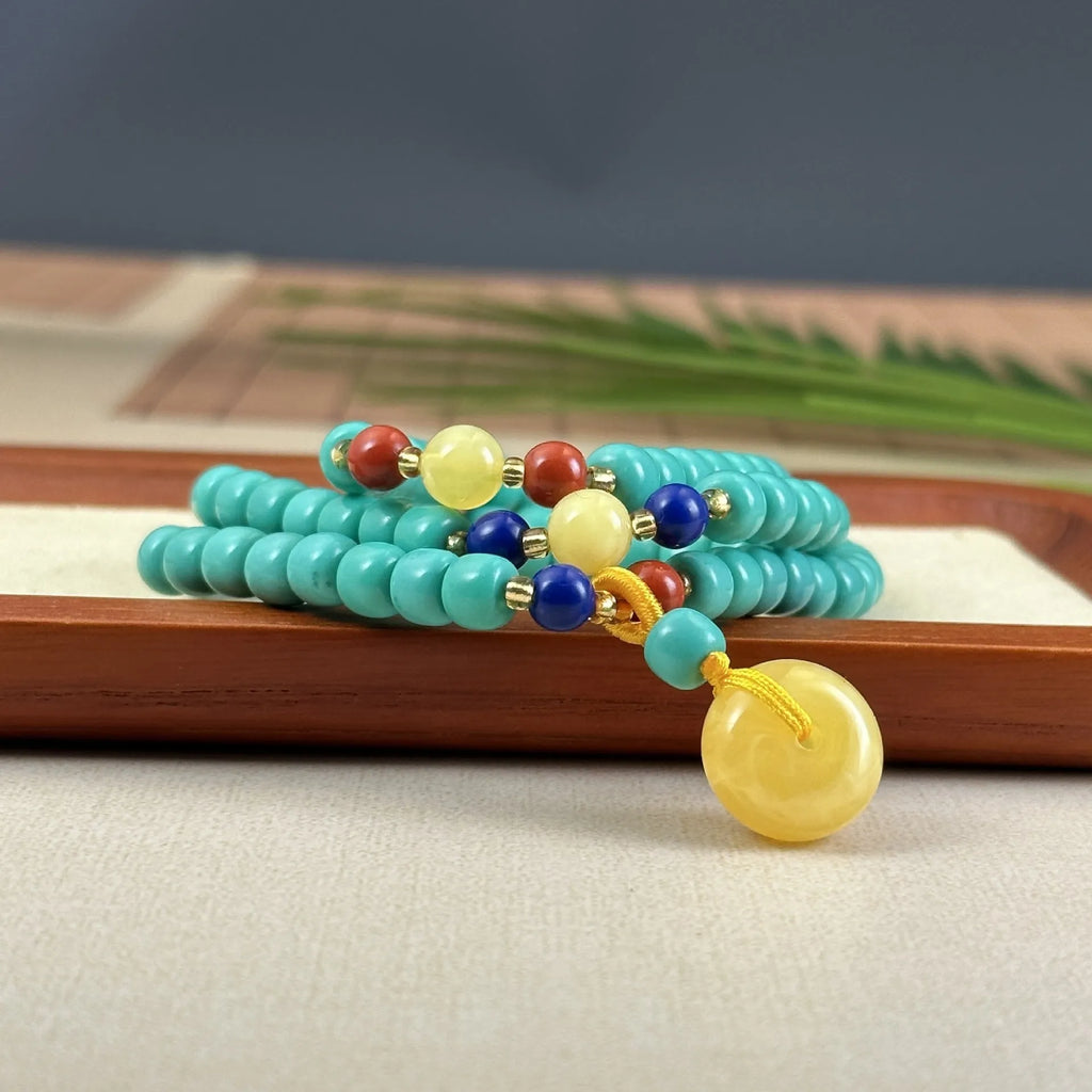 Turquoise necklace with stone pendant on ball bead chain, showing mesh flower design