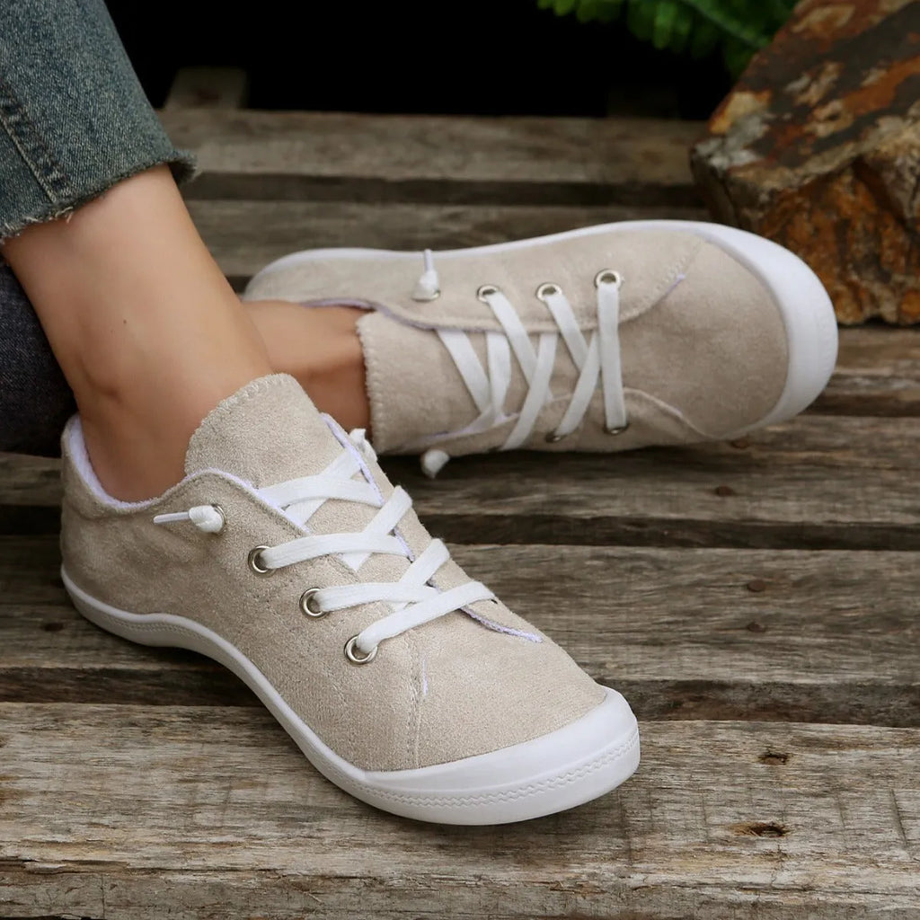Creamy-white women's low-top fabric casual sneakers with a rubber sole.