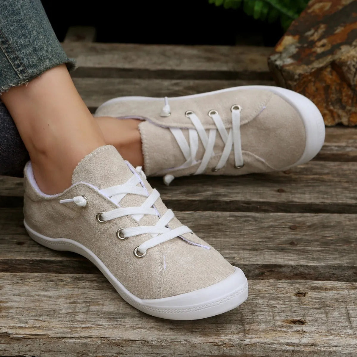 Creamy-white women's low-top fabric casual sneakers with a rubber sole.