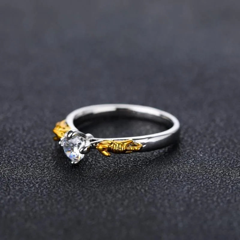 Copper crown crystal ring in black gold colour on a neutral background.