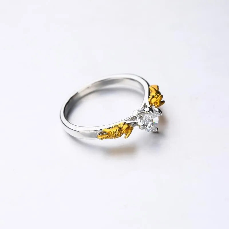 Copper crown crystal ring in black gold colour on a neutral background.