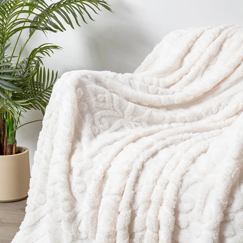 Shu cotton velvet jacquard blanket in a solid colour with a woven plant flower pattern, shown in one of five available colours.