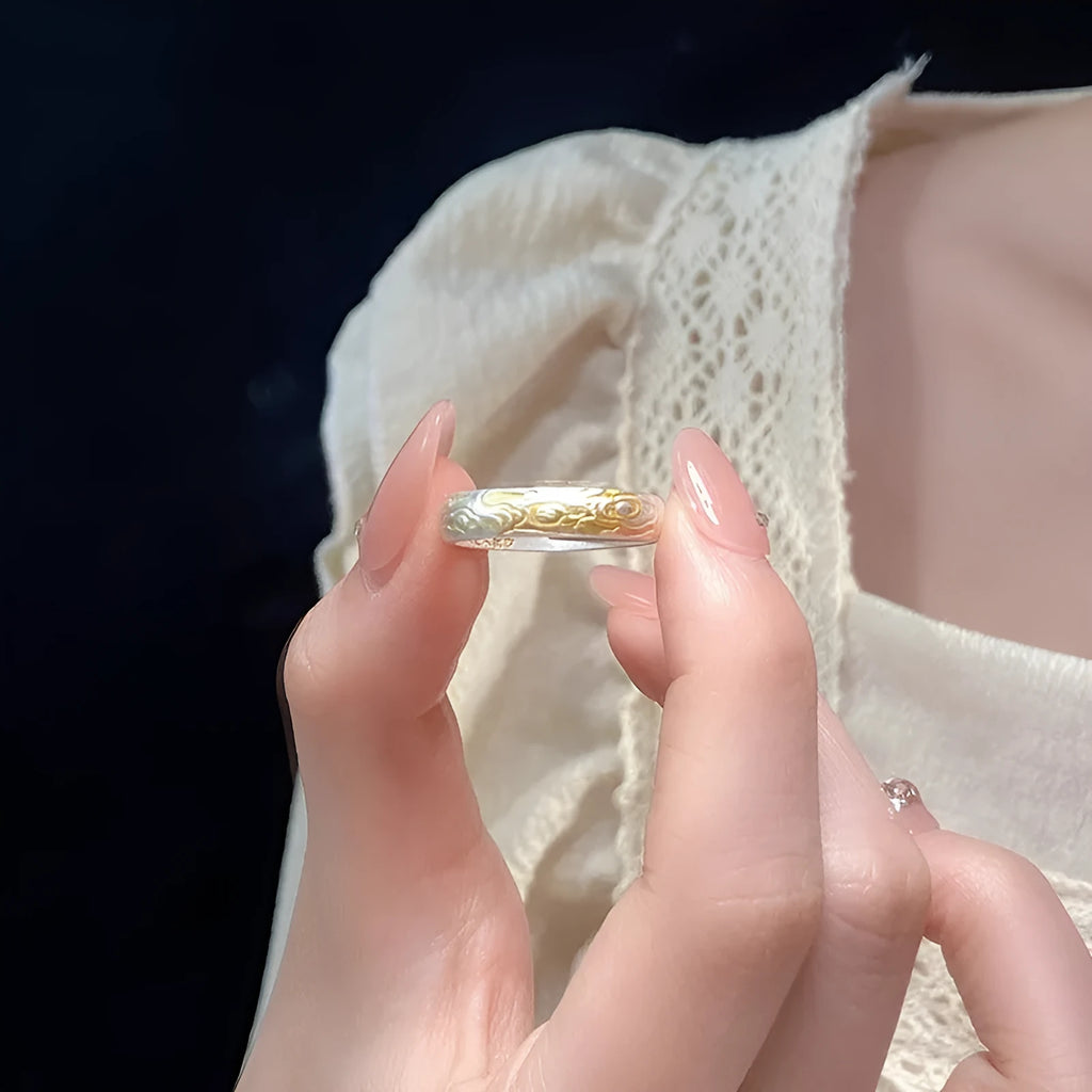Open-mouth geometric ring with engraved xiangyun pattern in electroplated white copper showing silver and gold finish options