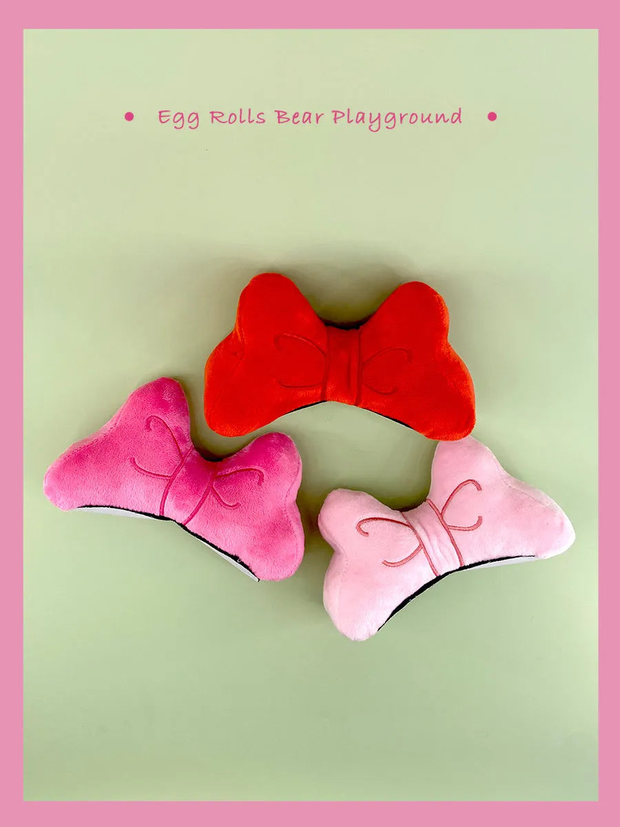 Soft plush bow decoration for motorcycle or ski helmet in red or pink colours