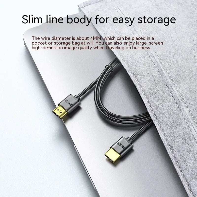 A thin, flexible HDMI cable with gold-plated connectors on a white background.