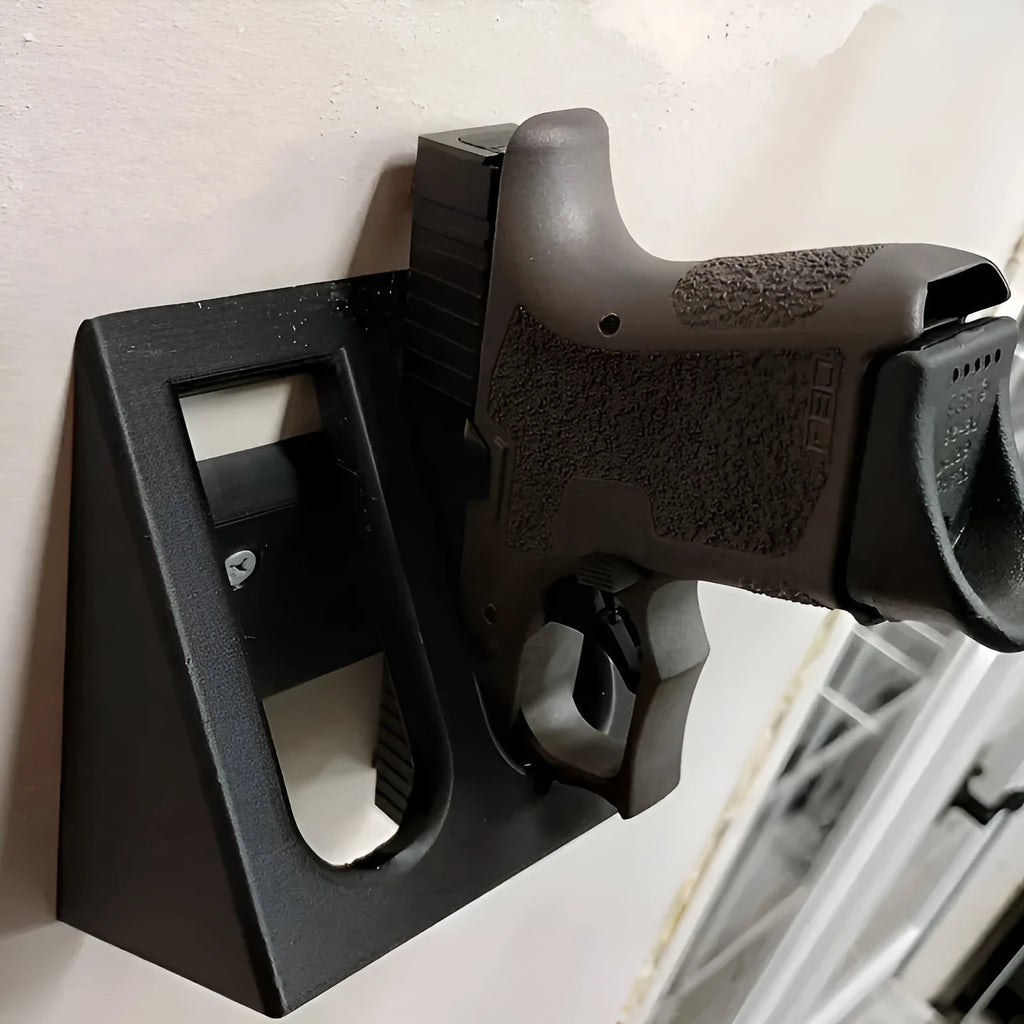 Black plastic punk-style pistol display stand on a flat surface.