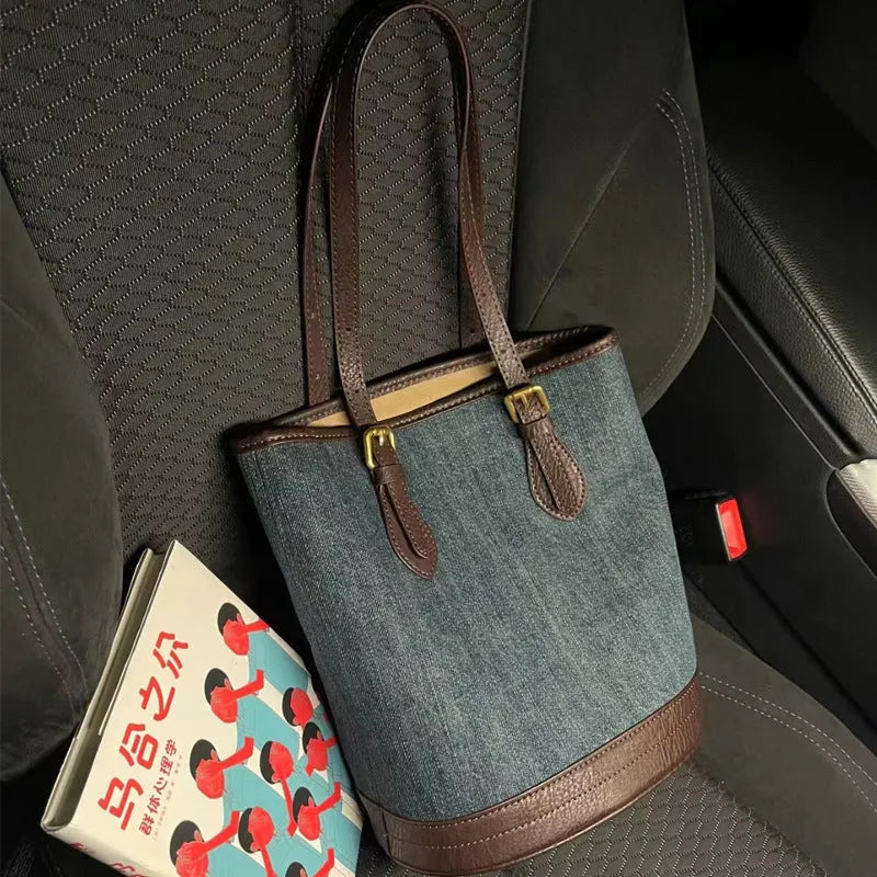 Denim patchwork handbag with one-shoulder bucket design showing dimensions