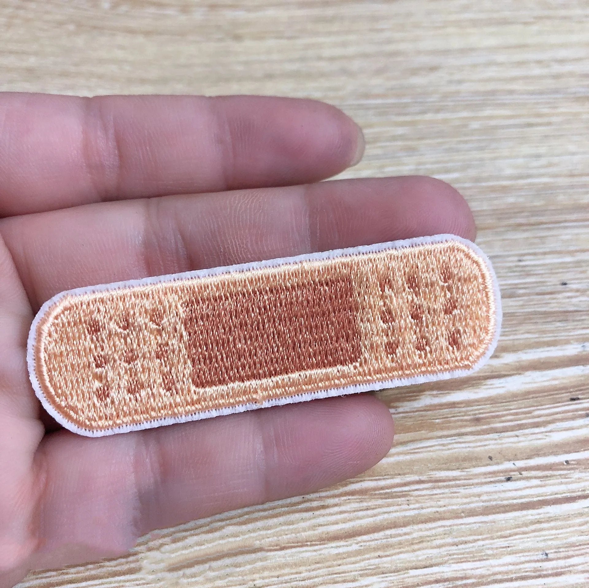 Ten computer-embroidered patch badges with adhesive backing for clothing decoration.