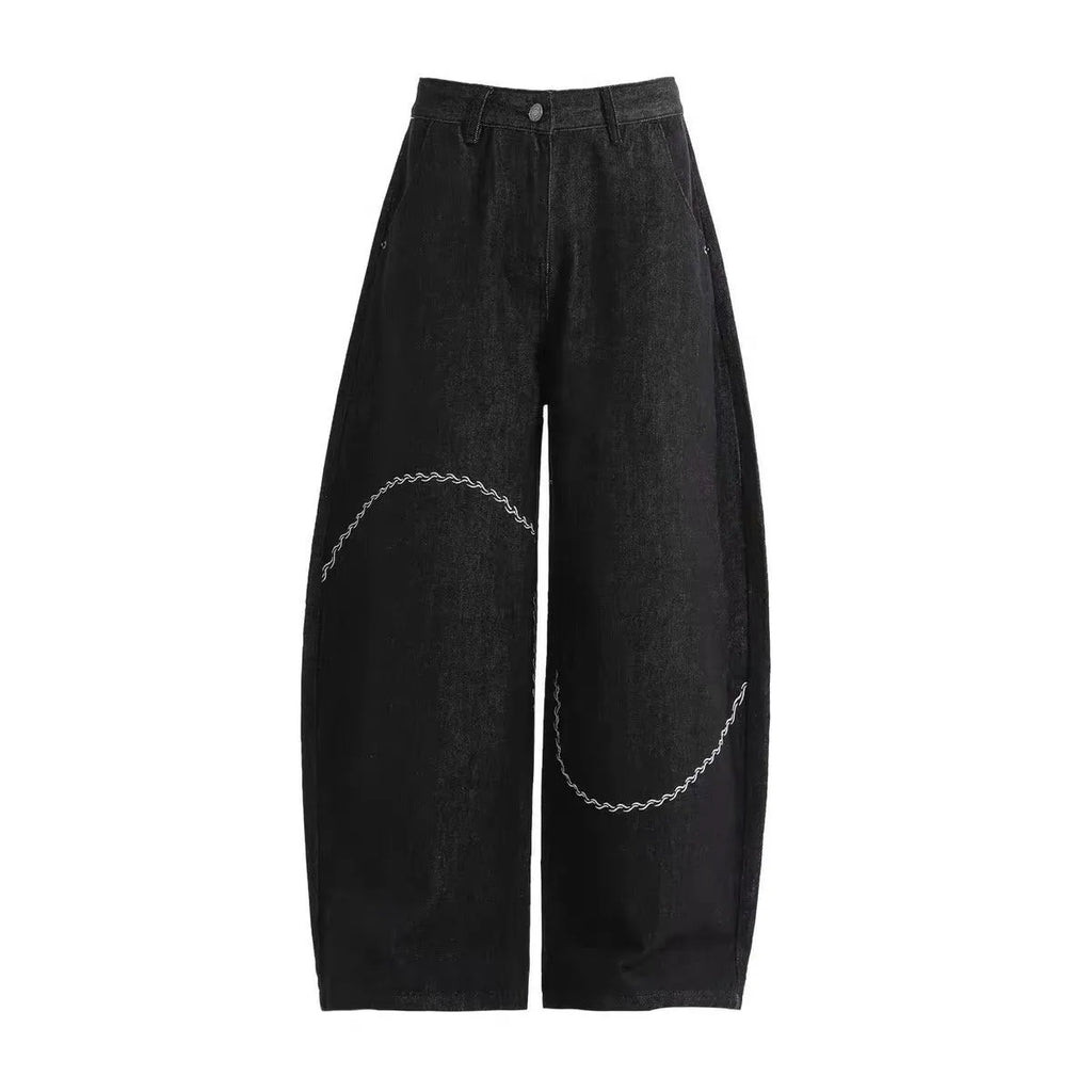 Black straight-leg jeans with micro-elastic polyester denim fabric showing zip fly and mid-rise waist