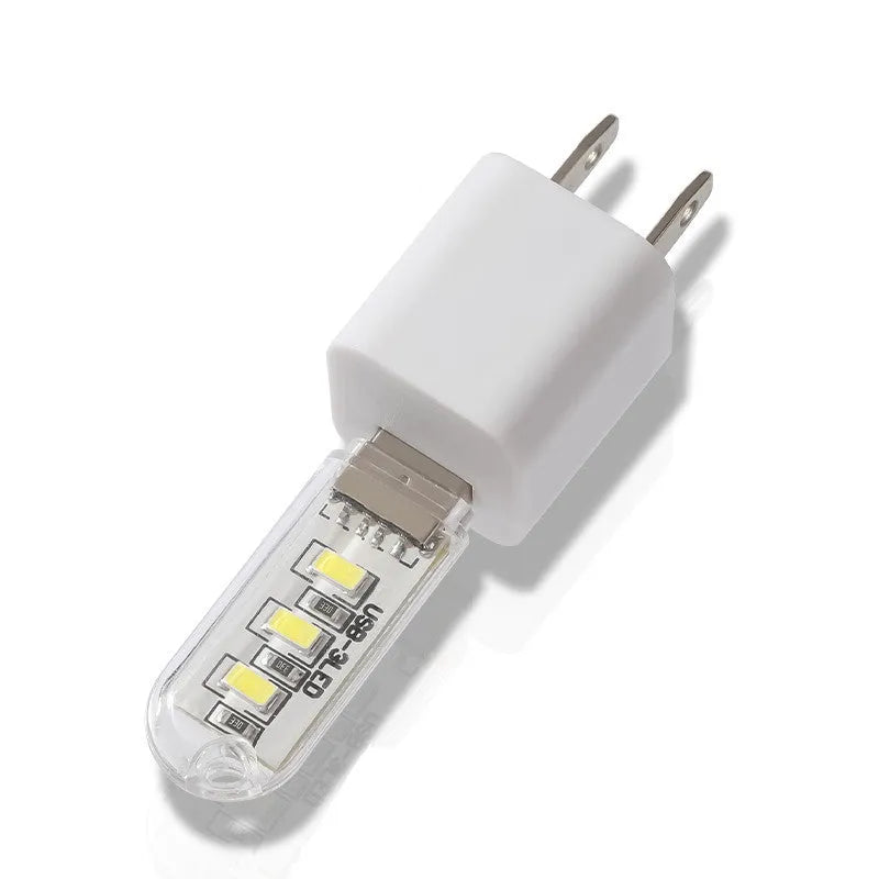 Small white USB LED baby night light showing warm and white light colour options.