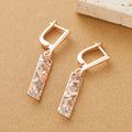 A pair of women's rectangular hollow stud earrings with a two-tone metal finish.