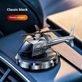 Silver solar-powered metal helicopter car air freshener ornament with rotating blades on a dashboard.