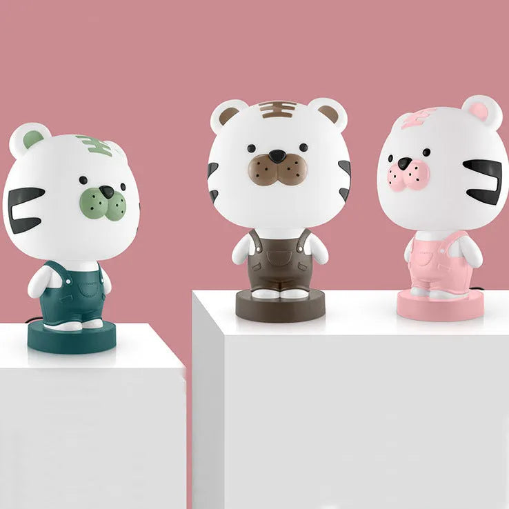 Cartoon animal table lamp in random bear, cattle, rabbit, or tiger design with plastic shade and LED light.