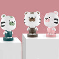 Cartoon animal table lamp in random bear, cattle, rabbit, or tiger design with plastic shade and LED light.