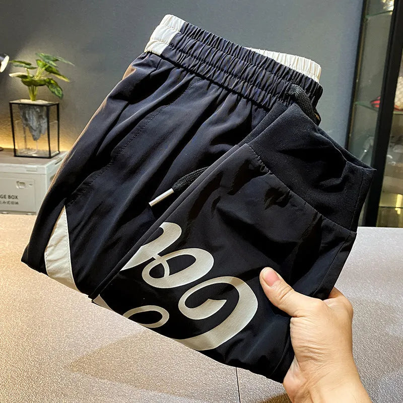 Black men's cropped casual trousers with an ankle band, made from thin Ice Silk cotton fabric.