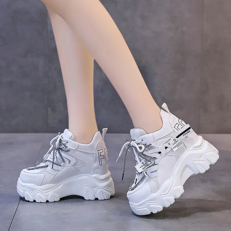 White women's mesh platform sports shoes with cross-strap detail and rubber sole.