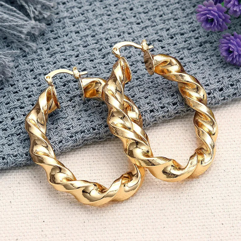 Geometric drop-shaped ear clips with ring and line design in metallic finish