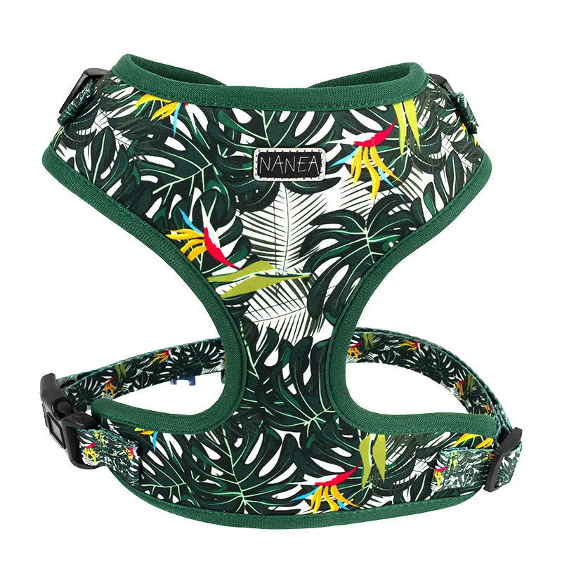 Six-piece adjustable cloth dog harness set on a table, showing vest, collar, rope, waste bag, bow, and triangular scarf.