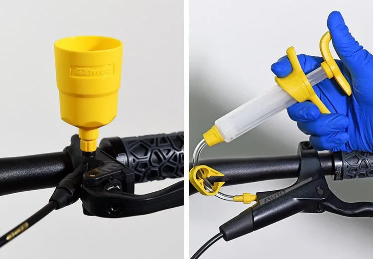 EZmtb bicycle hydraulic disc brake bleed kit with syringes, bottles, wrenches, and adapters on a workbench