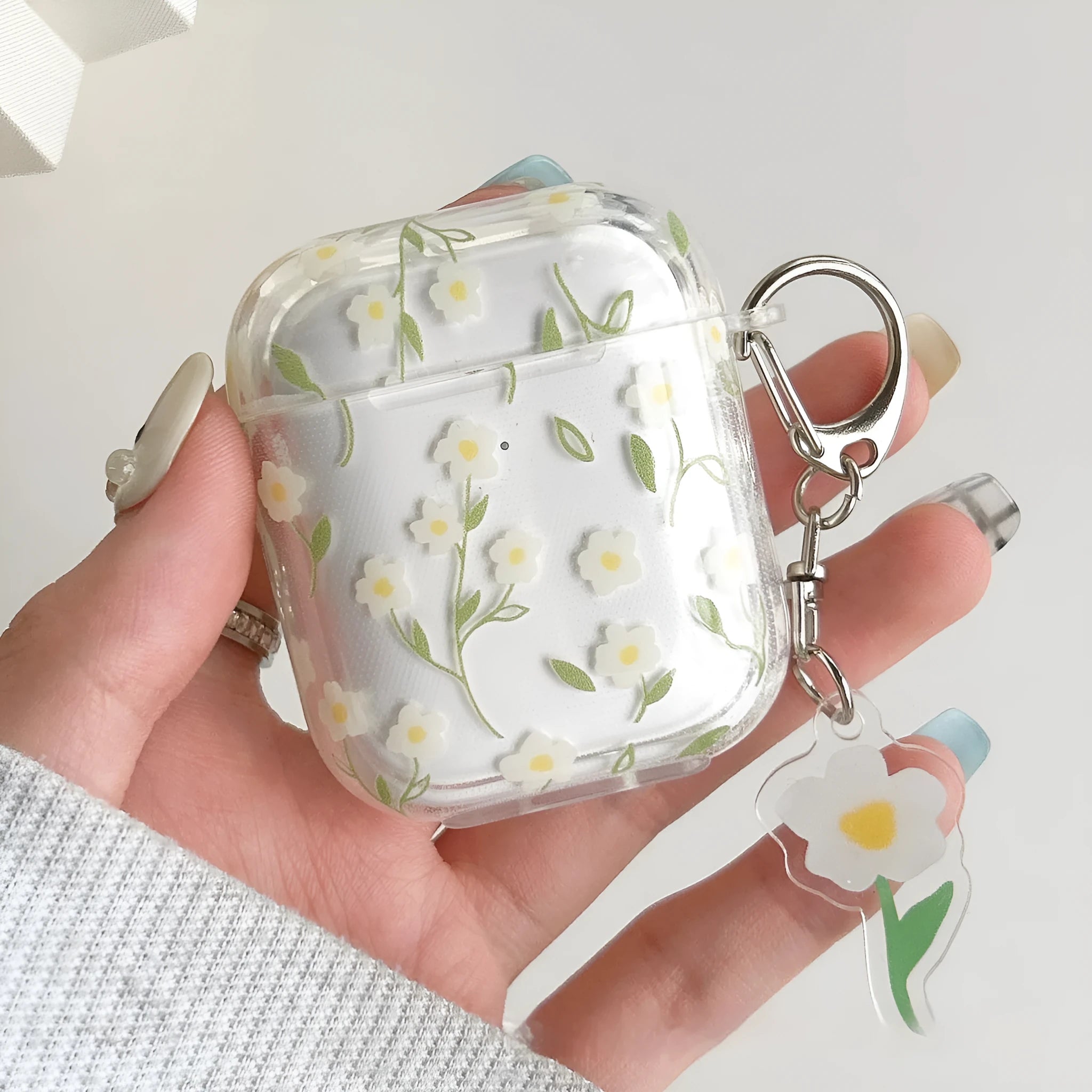 White floral design on a clear TPU protective cover for Apple AirPods case