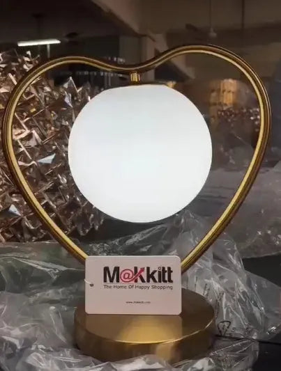 Heart-shaped decorative LED lamp with transparent acrylic detail emitting warm white light