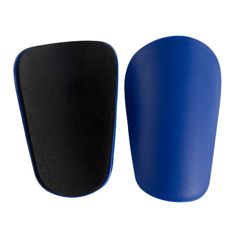 Pair of PU mini shin guards for sports protection in black, shown on a leg.