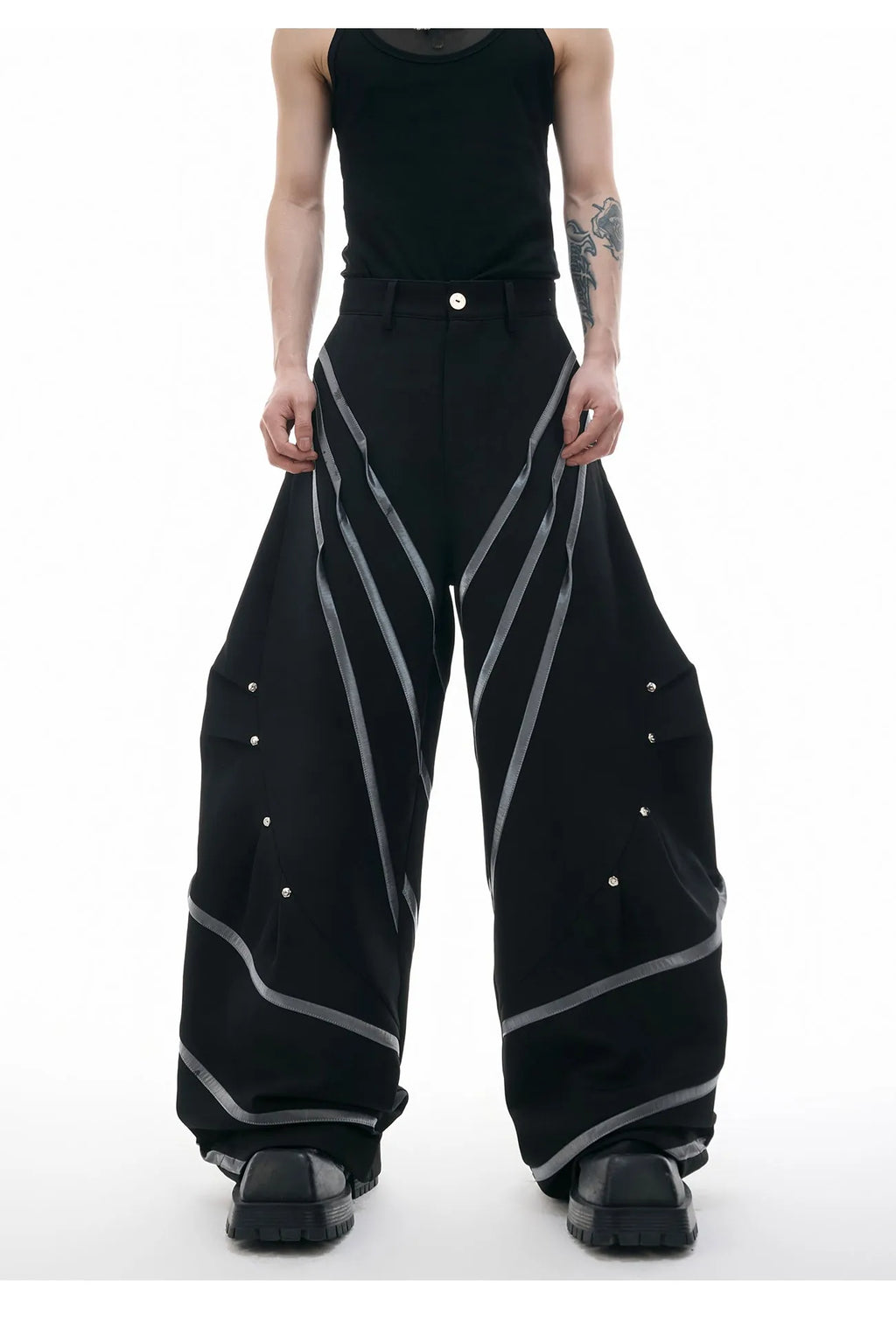 Men's trousers with deconstructed cut, metal striped rivets on pleats, and polyester fabric in black bottom colour
