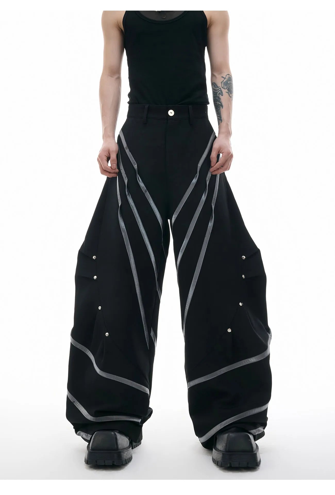 Men's trousers with deconstructed cut, metal striped rivets on pleats, and polyester fabric in black bottom colour