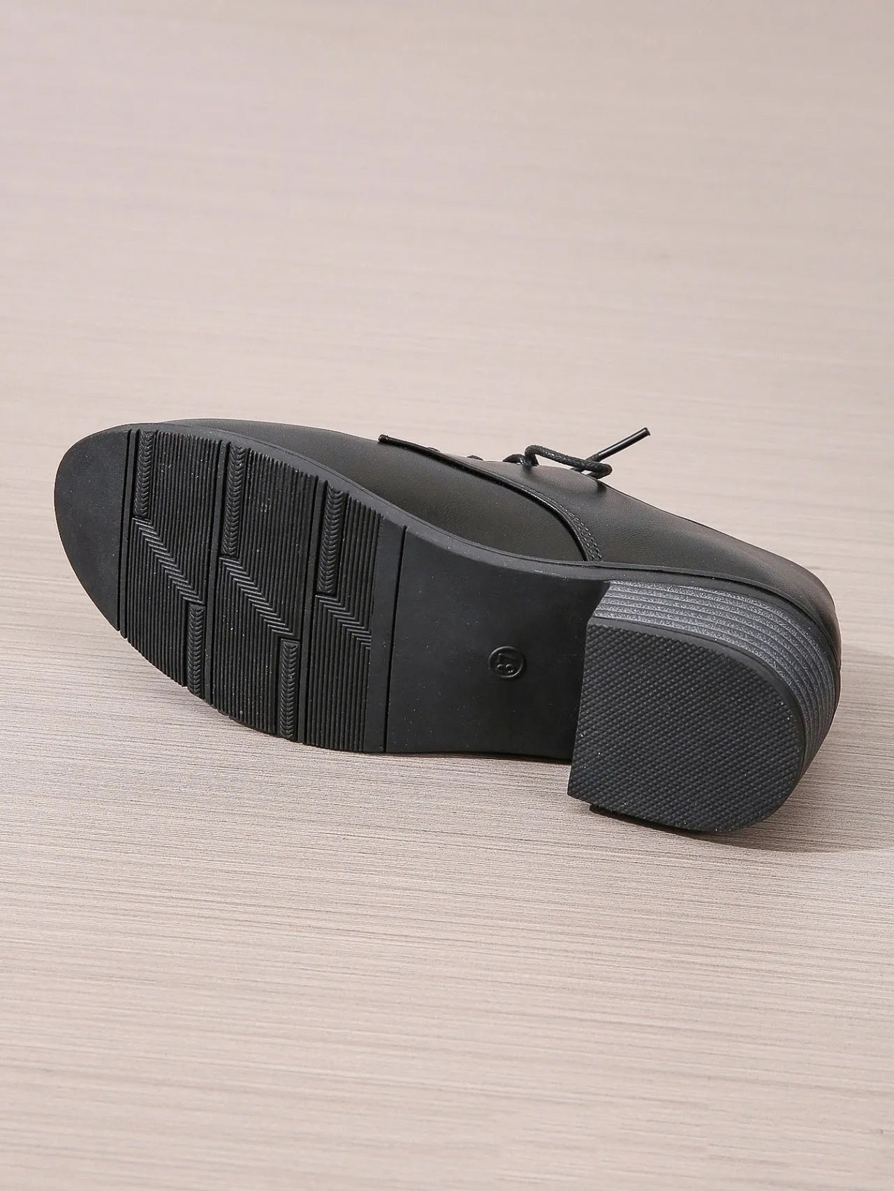 Black women's leather shoes with chunky heel, rubber sole, and low-top design for work and casual wear