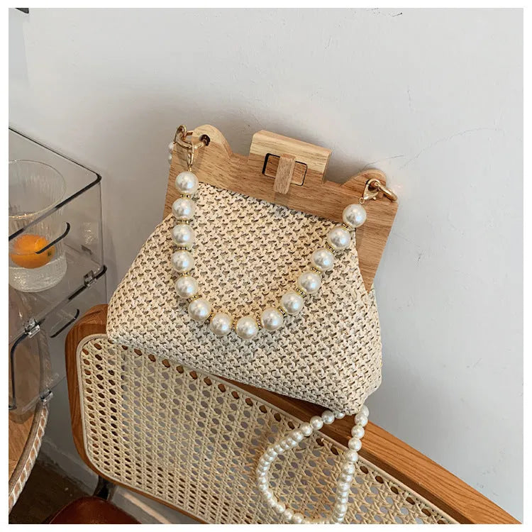 Women's straw shoulder bag with pearl chain detail in horizontal square shape