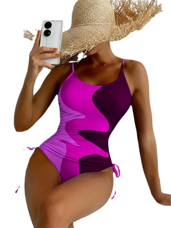 Women's blue sleeveless one-piece swimsuit with a striped pattern on a mannequin.