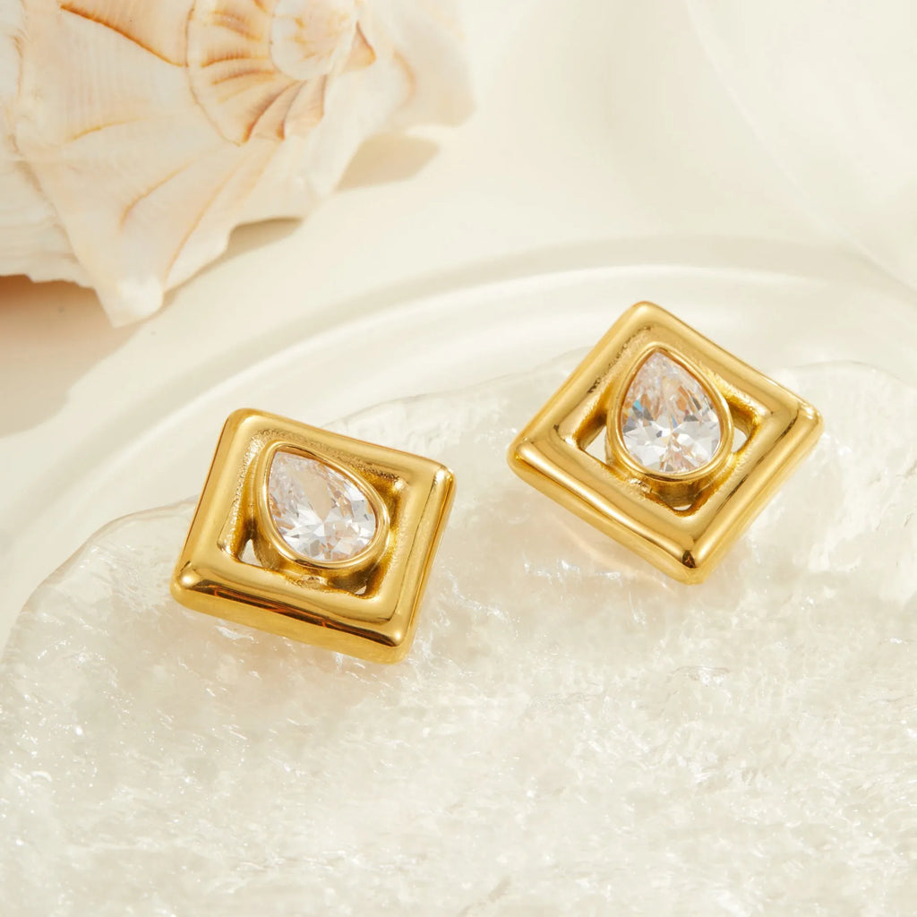 Gold-coloured geometry stud earrings with inlaid water drop zircon stones on a stainless steel base.