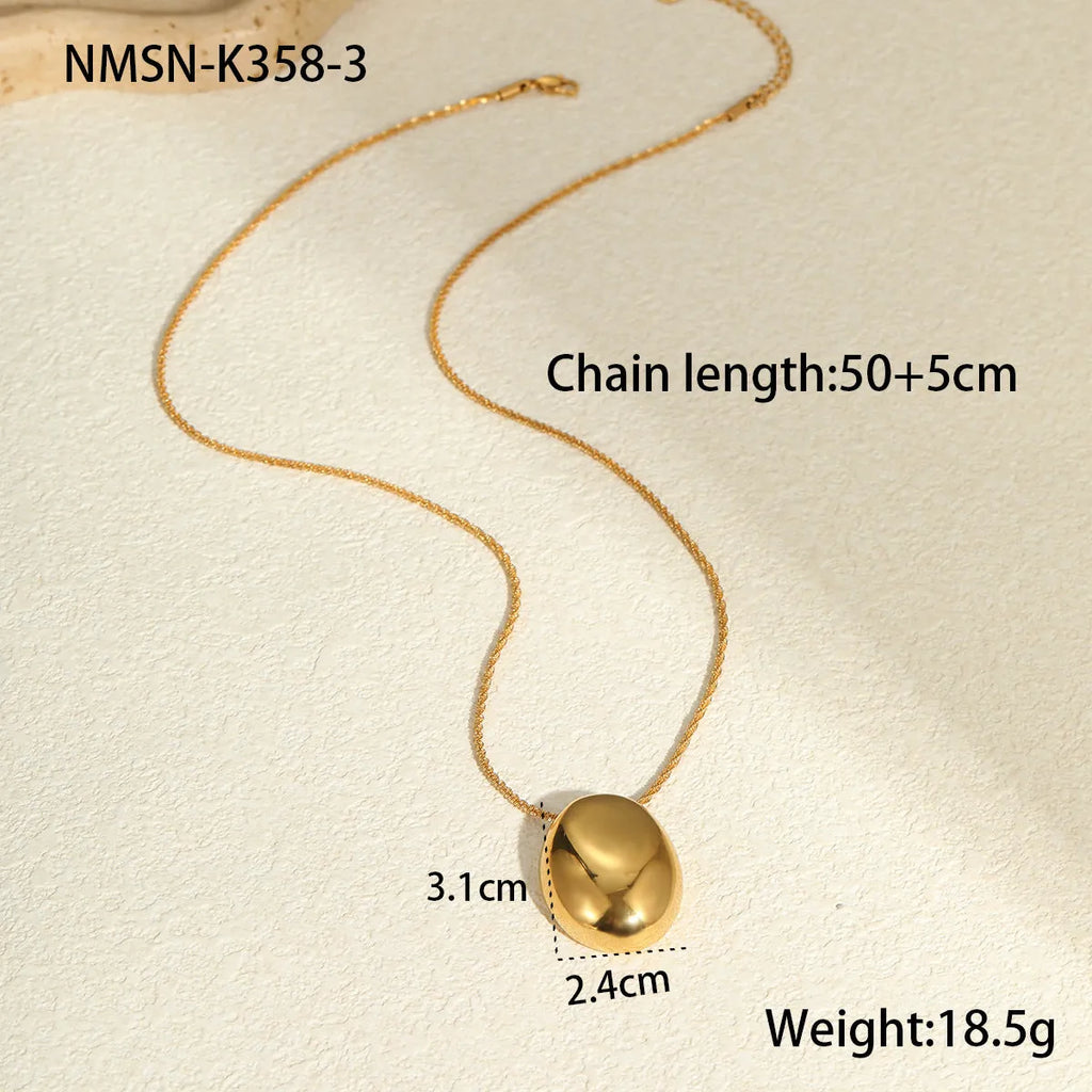 Gold geometric pendant necklace with regular chain on black background showing 41-50cm length
