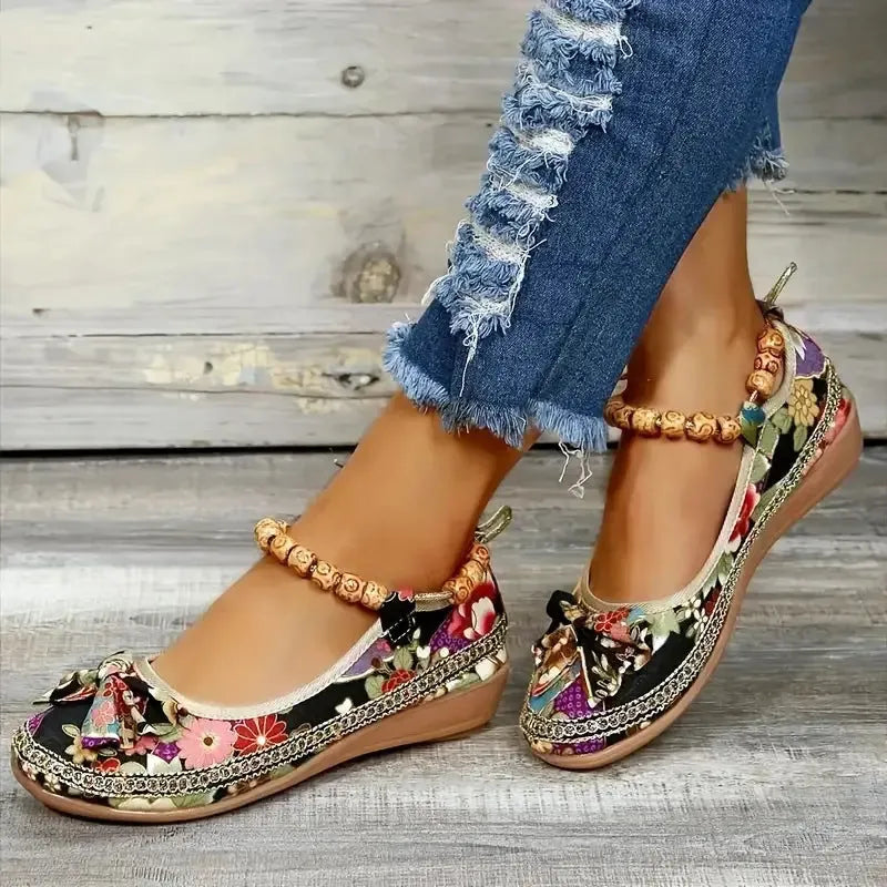 Women's black plus size ethnic platform sandals with cloth upper and elastic band.