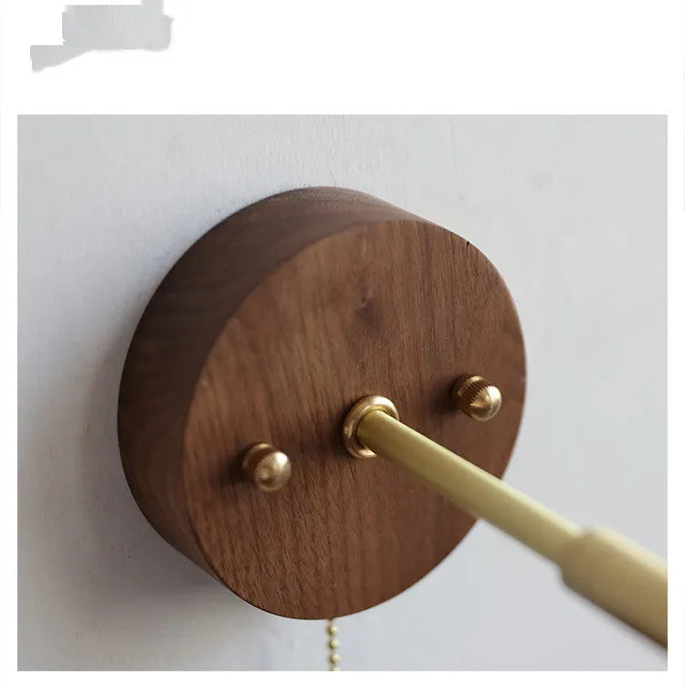 Nordic style wooden bedside wall lamp in walnut colour mounted on a wall.