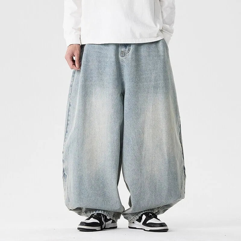 Men's plus size wide leg jeans in dark blue denim with a baggy fit and straight leg opening.