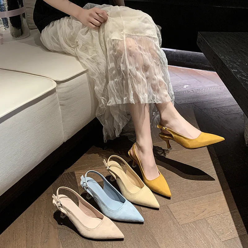 A pair of women's apricot suede stiletto heels with a pointed toe and thin high heel.