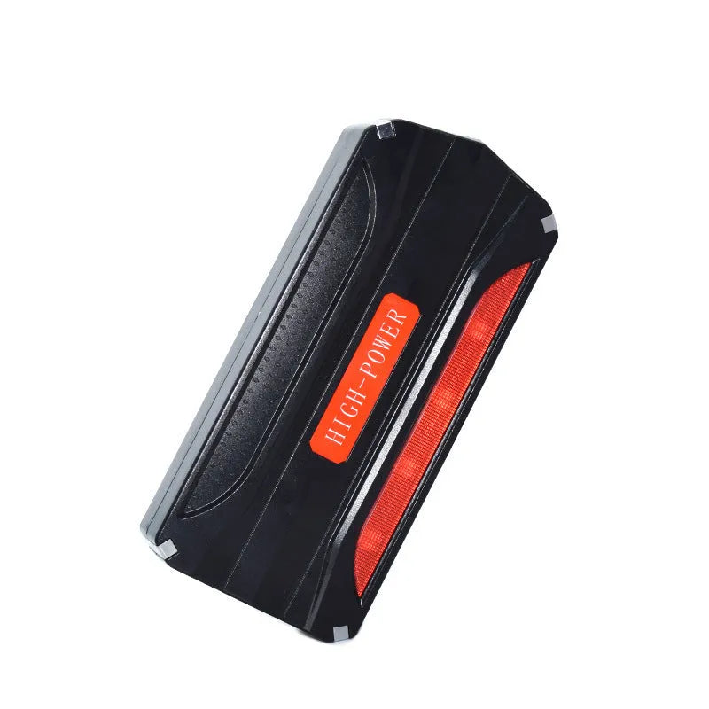 Black and red 12V vehicle emergency jump starter power supply unit on a white background.