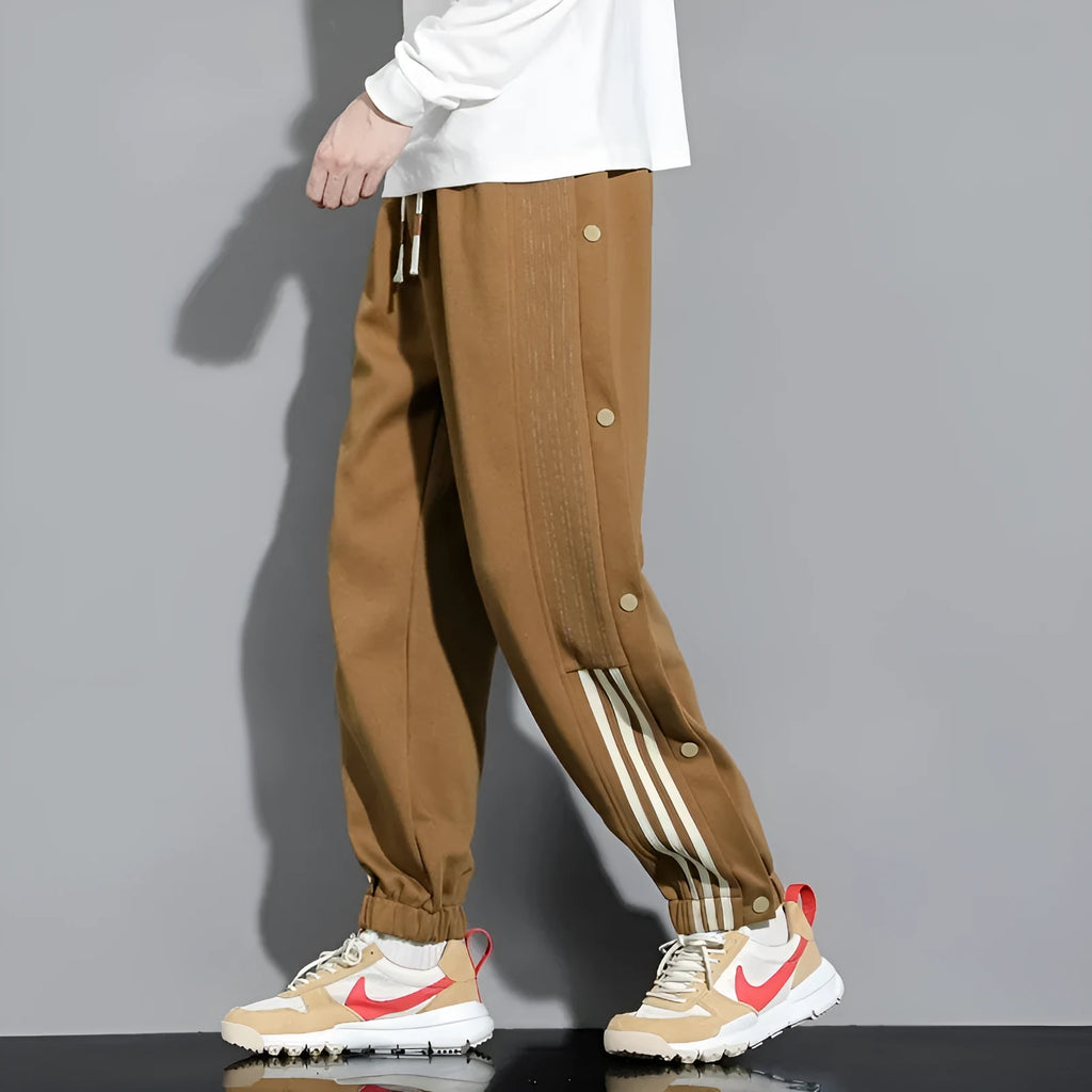 Men's loose fit ankle-tied sports pants in black with drawstring waist and elastic cuffs